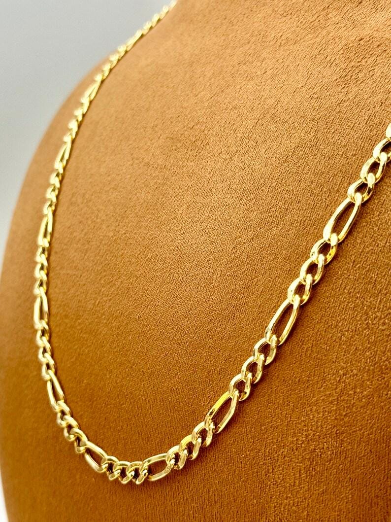 “Close-up of a 14K gold Figaro chain necklace, elegant and minimal everyday jewelry.”
