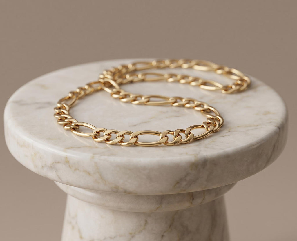 Close-up of a 14K gold Figaro chain necklace worn on a woman’s neck, featuring polished alternating links in a classic elegant design.